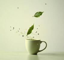 AI generated tea leaf falls from a cup in closeup green photo