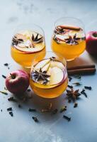 AI generated three glasses of apple cider with apples and spices photo