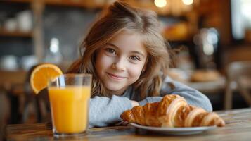 ai generado niña comiendo cuerno para desayuno con naranja jugo foto