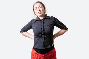 Suffering girl with back pain. Young woman with back pain. Lumbar problems concept. People with spine problems isolated photo