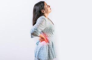 Suffering girl with back pain isolated. Young woman with spine problems isolated. Person with back pain. lumbar problems concept photo