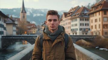 ai generado joven hombre mirando a el cámara mientras en pie en un puente en un antiguo europeo pueblo foto