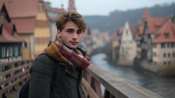 ai generado joven hombre mirando a el cámara mientras en pie en un puente en un antiguo europeo pueblo foto