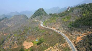 Vehicles driving on scenic mountain road, North Vietnam video