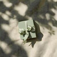 AI generated Flat lay top-down shot sage green ring box with cute tape bow. Present box under the sun on the light background. AI Generative photo