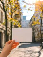 AI generated Empty postcard in a woman's hand in the center of the autumn city. Mock up of a horizontal postcard. High quality. AI Generative photo