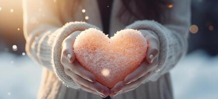 AI generated women's hands holding a heart of snow to create a beautiful mood in winter, photo