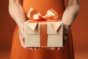 AI generated a womans hand holds the gift box with a ribbon photo