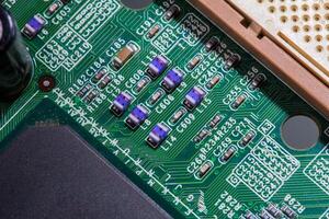 old digital circuit board with microprocessors and components, closeup full-frame macro background photo