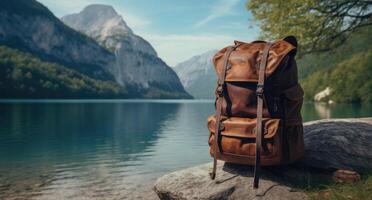 AI generated an old brown backpack sits on top of a rock overlooking an idyllic lake photo