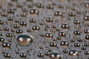 water drops on surface of screen of cellphone, close-up with selective focus and blur photo