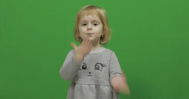 Kid girl making a fly kisses on a Green Screen, Chroma Key video