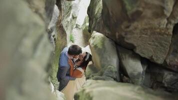 noivo com noiva em pé dentro caverna do montanha colinas. Casamento casal dentro amor video