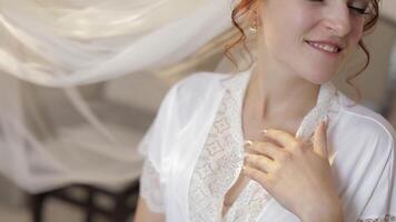 Beautiful and lovely bride in night gown and veil. Wedding morning. Slow motion video
