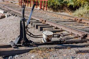 manual railroad switch with lever and counterweight at summer day photo