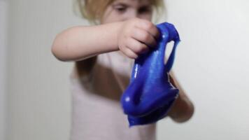 Child having fun making slime. Kid playing with hand made toy slime. video