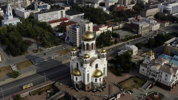 Aerial view of city sleeping area with many residential houses and a church with golden domes. Stock footage. Summer city and green streets. photo