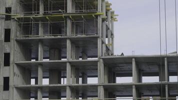 Building construction site work against blue sky. Workers at the construction site of an apartment building photo