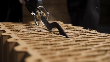 Close up of a man using electric saw to cut through a block in a cloud of dust. Stock footage. Details of new brick house building. photo