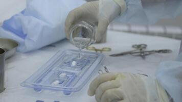 Laboratory worker pours disinfectant liquid into flat flask. Action. Concept of chemistry and science. photo