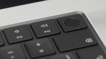 Laptop keyboard. Action. A person sits at a computer and works in modern conditions, close shooting of the keyboard and the printing process. photo