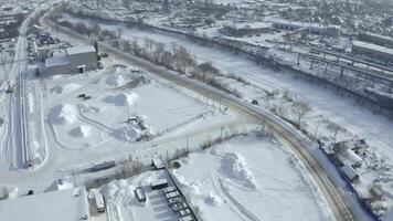 Top view of industrial area in winter. Clip. Industrial area in countryside on winter day. Small businesses outside city in winter photo