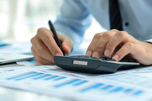 AI generated Financial data analyzing counting concept for Businessman's hands with calculator and laptop on desk in modern office. Generative AI photo