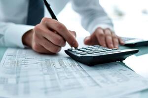 AI generated Financial data analyzing counting concept for Businessman's hands with calculator and laptop on desk in modern office. Generative AI photo