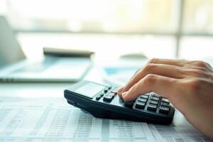 AI generated Financial data analyzing counting concept for Businessman's hands with calculator and laptop on desk in modern office. Generative AI photo