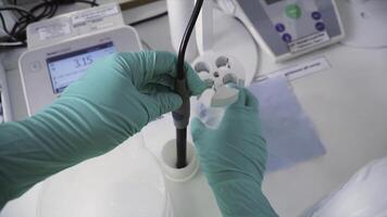 First-person view of staff working in a laboratory. Clip. Young chemical technician checking liquid reagent in laboratory, first-person view photo