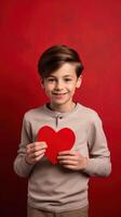 AI generated A young boy with a red paper heart on his hand isolated on red valentine background photo