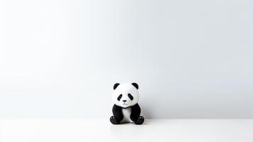 ai generado linda pequeño panda juguete sentado en blanco antecedentes con Copiar espacio. foto