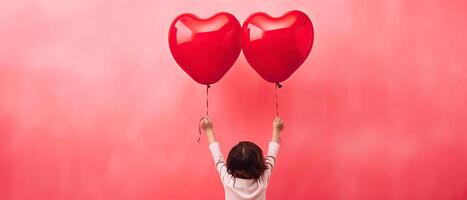 ai generado posterior ver de un niño levantamiento brazos con rojo amor enamorado corazón conformado globo aislado en rosado antecedentes foto