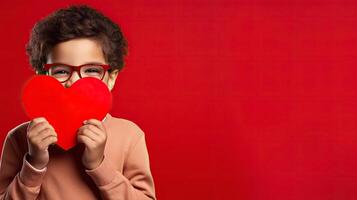 AI generated A shy little boy holding a paper heart shape and hiding behind it on grey background photo