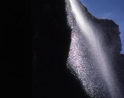 a waterfall is being sprayed with water photo