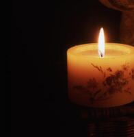 a candle is lit in the dark photo