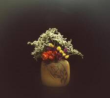 a vase with flowers in it photo
