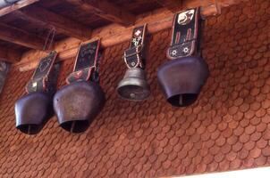 a wall with bells hanging from it photo