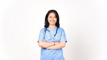 Young Asian female doctor folding arms smiling and looking at camera isolated on white background photo