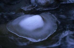 a rock with ice on it photo