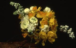 a bouquet of yellow and white flowers is shown photo