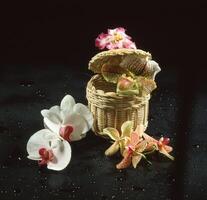 a basket with flowers and a wicker basket photo