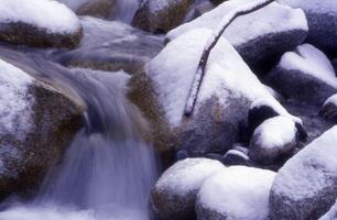 a stream of water flowing over rocks photo