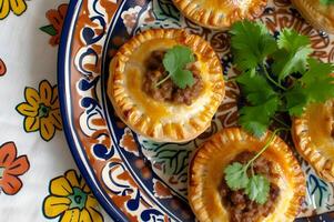 AI generated Authentic Brazilian Flavors Mini Meat Pies on Folk-Patterned Tray photo