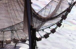 a boat with a net hanging from it photo