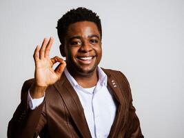 Portrait of happy businessman who is smiling and showing excellent sign. Copy space on image for your text or advert. photo