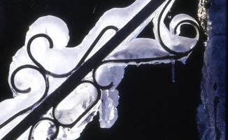 a white railing with ice on it photo