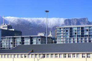 Capetown, South Africa, October 28, 2022 - Administration buildings and Table Mountain covered with clouds, Cape Town, South Africa photo