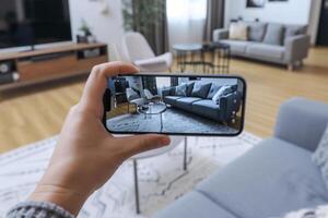 AI generated Hands hold smartphone with augmented reality interior design software to choose furniture. Generative AI photo