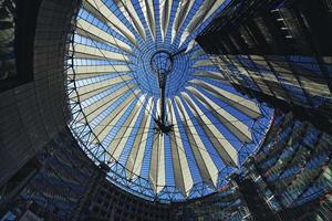 Berlin, Germany, 2021 - Tented glass roof dome with skyscrapers of the Sony Center, Potsdam Square, Berlin, Germany photo